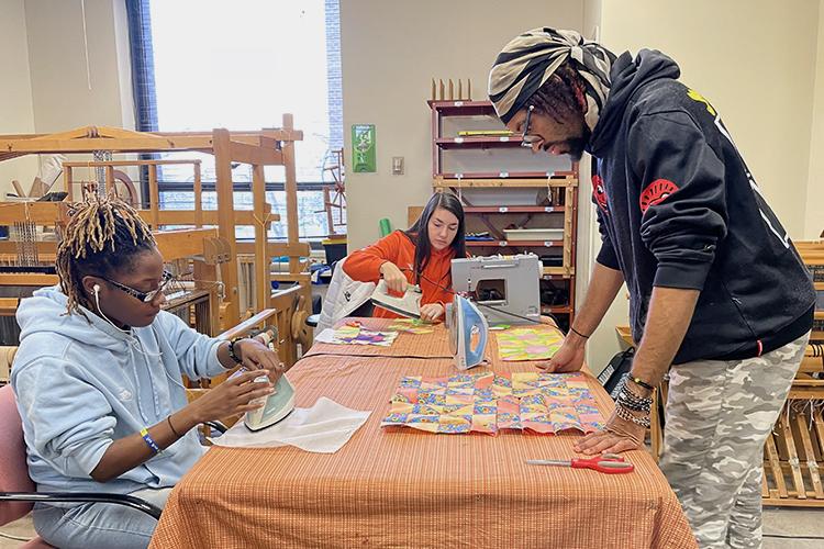 CSU Art and Design Fiber Arts Weaving studio with 3 students creating fiber arts